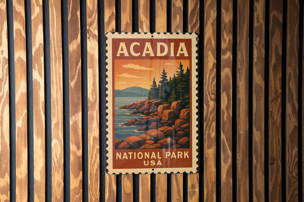 A vintage-style postage stamp depicting a scenic landscape with mountains, pine trees, and rocky cliffs, hanging on a wooden wall.