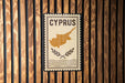 a sign with the word "CYPRUS" and a map of the island of Cyprus.
