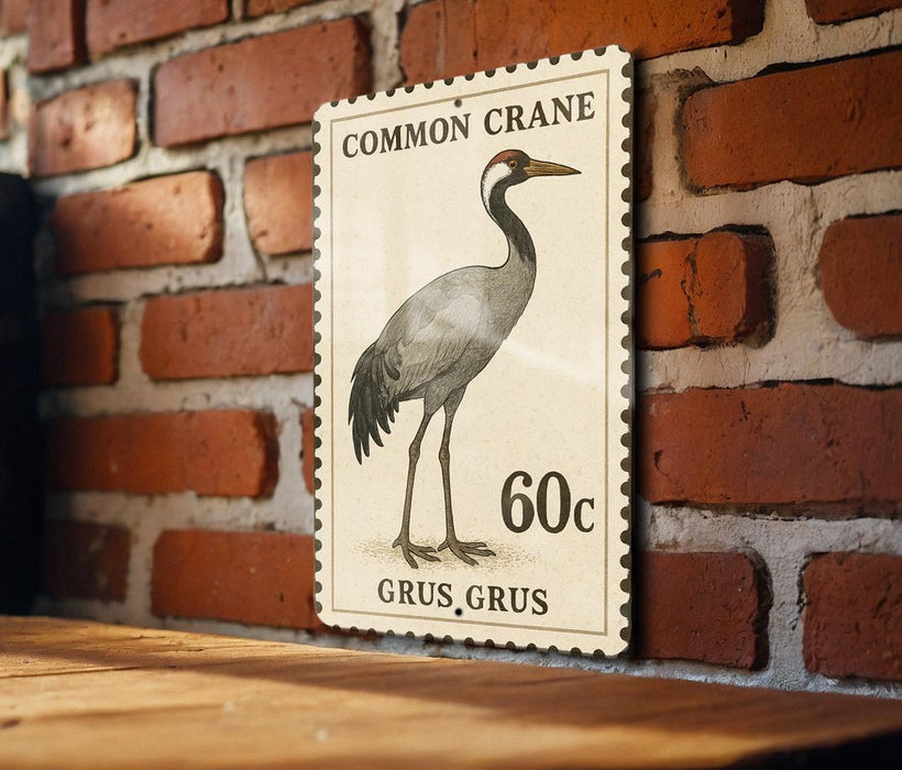 a postage stamp with a drawing of a crane, mounted on a brick wall.