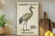 a postage stamp with a drawing of a crane, along with the text "Common Crane" and "60c Grus Grus".