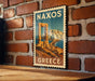 A vintage postage stamp depicting the Greek island of Naxos, with the text "NAXOS GREECE" prominently displayed.