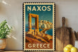 A vintage-style metal sign with the text "NAXOS GREECE" displayed prominently, featuring an illustration of a Greek island with a temple or monument in the background.
