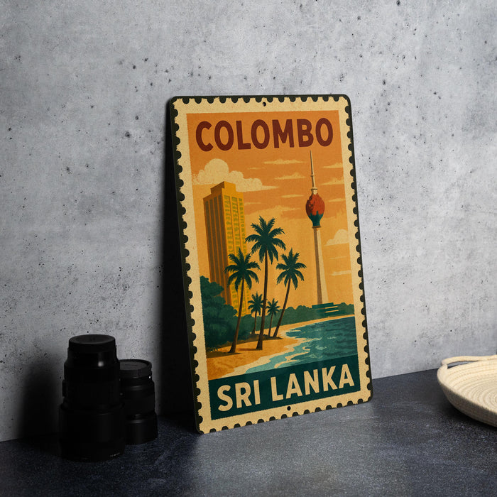 A vintage-style metal sign with the text "COLOMBO SRI LANKA" and an illustration of a tropical beach scene with palm trees and a tower.