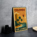 A vintage-style metal sign with the text "COLOMBO SRI LANKA" and an illustration of a tropical beach scene with palm trees and a tower.