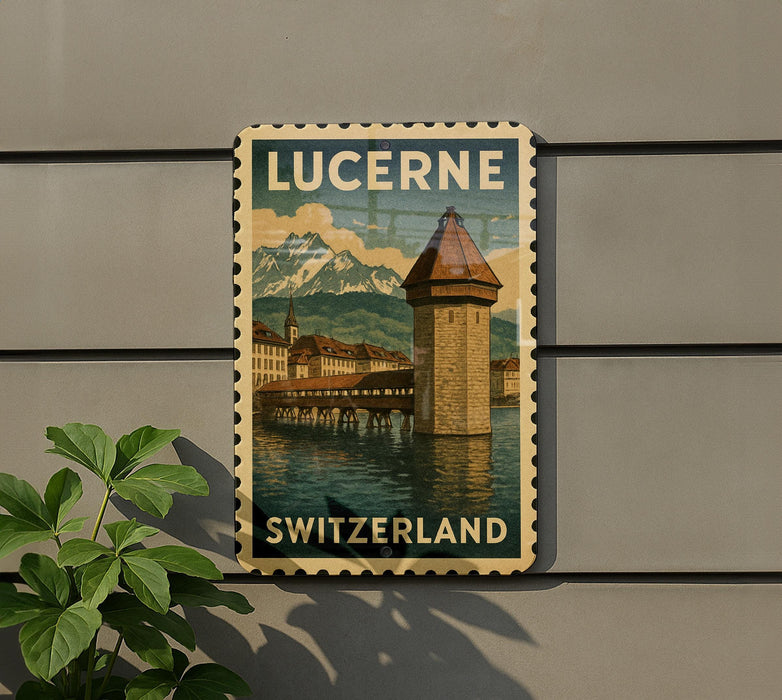 A vintage postage stamp depicting the Lucerne, Switzerland landmark, with a mountain backdrop and a tower in the foreground.