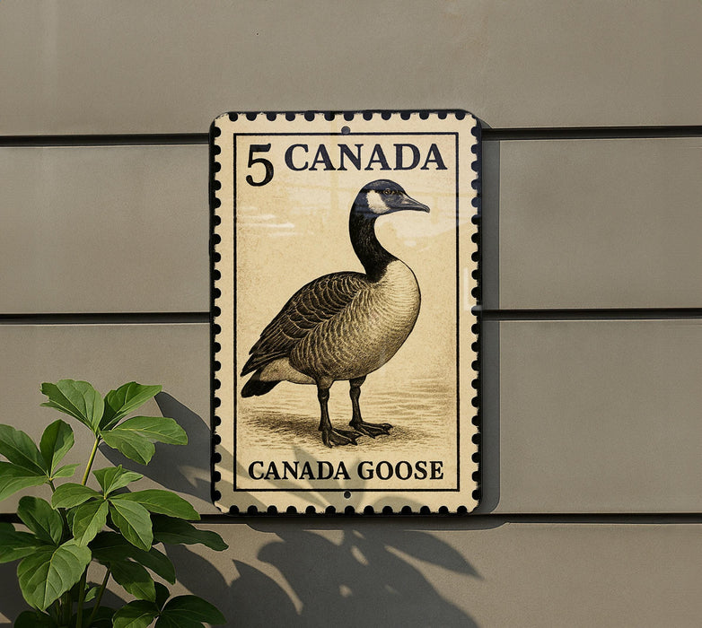 A 5 Canada goose postage stamp is displayed on a wall, with a plant visible to the left.