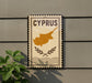a sign with the word "CYPRUS" on it, along with a map of the island of Cyprus.
