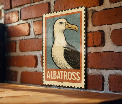 A framed illustration of a seagull is displayed on a brick wall, with the word "ALBATROSS" written below the image.