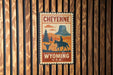 A vintage-style poster of Cheyenne, Wyoming, featuring a cowboy on horseback and a mountain in the background.