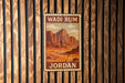 A vintage-style poster of Wadi Rum, a famous landmark in Jordan, is displayed on a wooden wall.