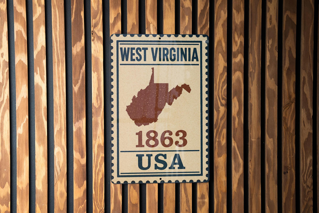 A vintage-style metal sign with the text "WEST VIRGINIA 1863 USA" displayed on a wooden wall.