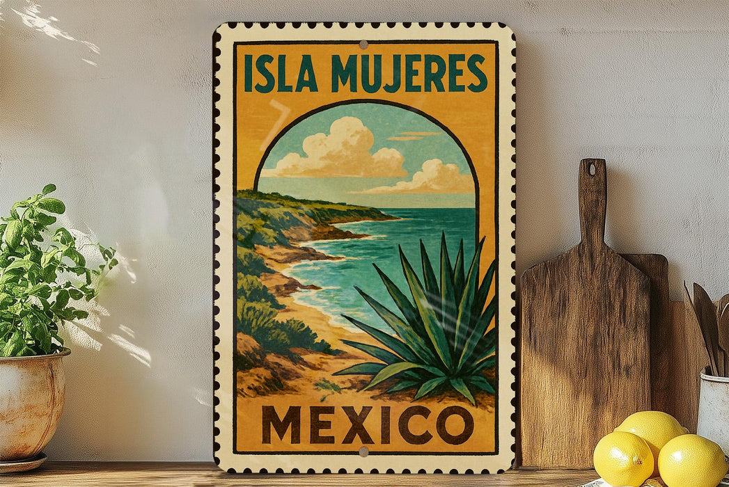 A vintage-style metal sign with the text "ISLA MUEJERES MEXICO" and an illustration of a desert landscape with a cactus plant, all set against a white wall.