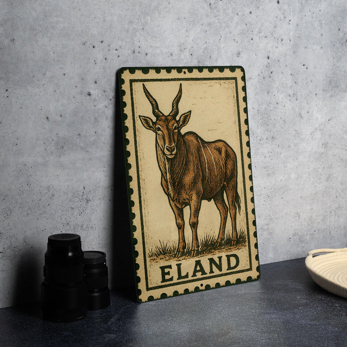 a metal sign with a picture of an animal, specifically an antelope, and the word "ELAND" written on it.