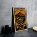 A vintage-style metal sign with a landscape and a mountain, featuring the text "SICILY ITALY" on it, is displayed on a table.
