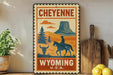 A vintage-style metal sign with the text "CHEYENNE WYOMING U.S.A." displayed prominently, featuring a cowboy riding a horse and a mountain in the background.