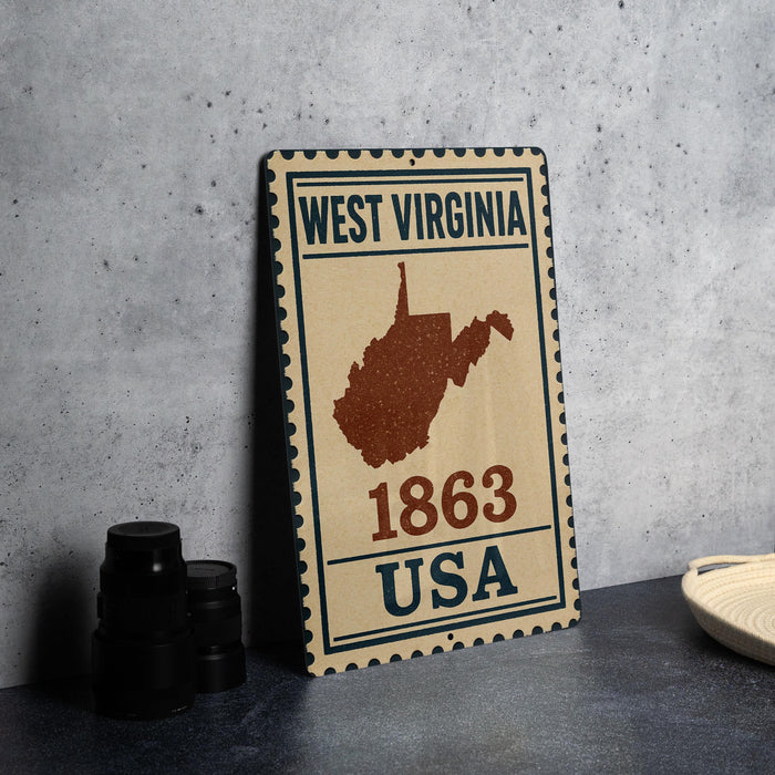 A vintage-style metal sign with the text "WEST VIRGINIA 1863 USA" and a map of the state of West Virginia.