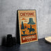 A vintage-style metal sign with a cowboy riding a horse, depicting the scenic landscape of Cheyenne, Wyoming, USA.
