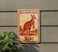A red kangaroo stamp is mounted on a wall, with a plant visible to the left.