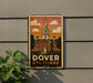 A vintage-style postage stamp depicting the historic Dover, Delaware, with a building and a clock tower.