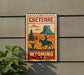 A vintage-style metal sign with a cowboy silhouette and a mountain landscape, mounted on a wall.