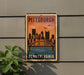 A vintage-style metal sign with the text "PITTSBURGH PENNSYLVANIA" and an illustration of a city skyline with a bridge.