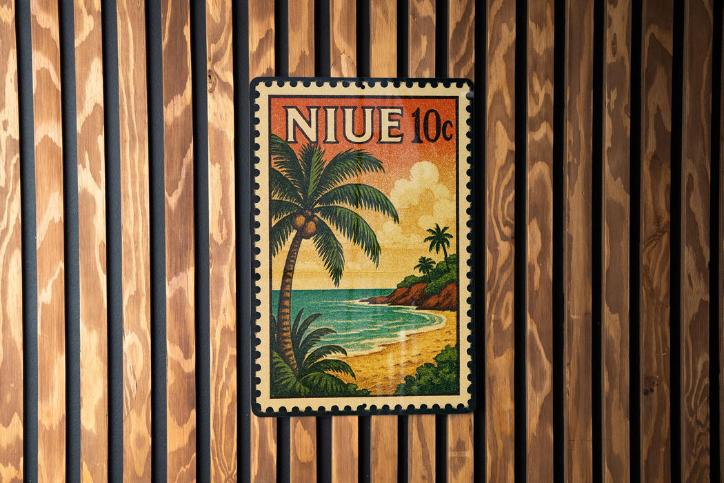 A vintage postage stamp featuring a tropical beach scene with palm trees and a sunset over the ocean.
