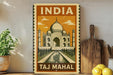 A vintage-style metal sign with the text "INDIA TAKJ MAHAL" and an illustration of the Taj Mahal, a famous mausoleum in India.