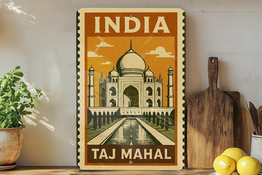 A vintage-style metal sign with the text "INDIA TAKJ MAHAL" and an illustration of the Taj Mahal, a famous mausoleum in India.