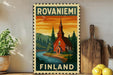 a poster of a church with a scenic landscape in the background, displayed on a wall next to a wooden cutting board and some potted plants.