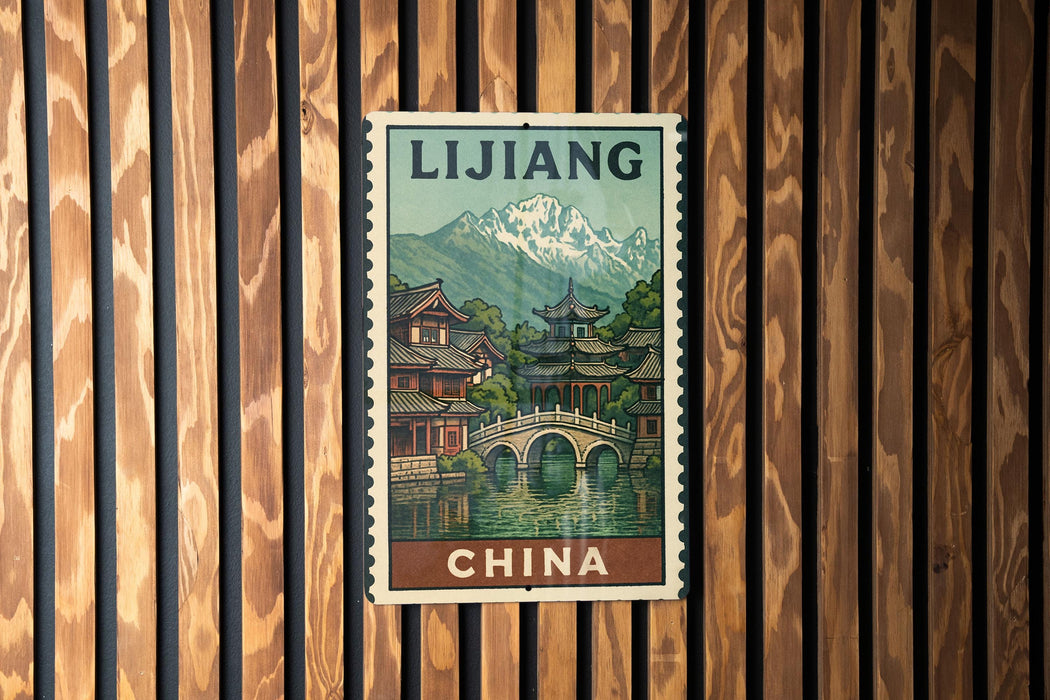 A vintage postage stamp from China depicting a traditional Chinese village with a bridge and mountains in the background.