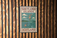 A vintage-style metal sign with the text "SHETLAND ISLANDS SCOTLAND" displayed on a wooden wall.