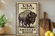a metal sign with a bison illustration, placed on a wooden surface next to a wooden cutting board and some lemons.