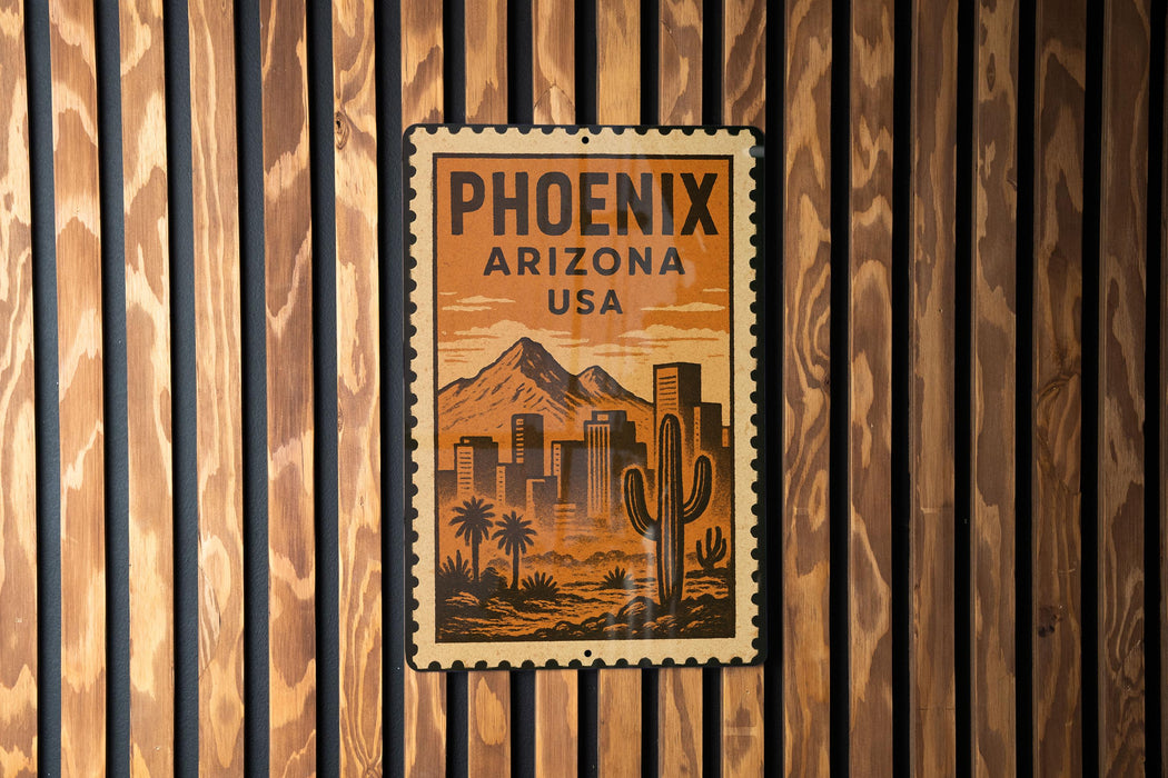 A vintage-style metal sign with the text "PHOENIX ARIZONA USA" displayed on a wooden wall.