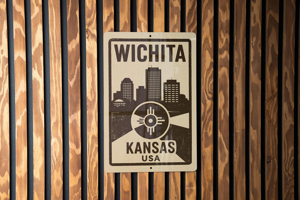 A sign that reads "WICHITA KANSAS USA" is displayed on a wooden wall.