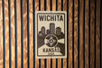 A sign that reads "WICHITA KANSAS USA" is displayed on a wooden wall.