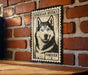 A metal sign featuring a black and white illustration of a Siberian Husky dog, mounted on a brick wall.