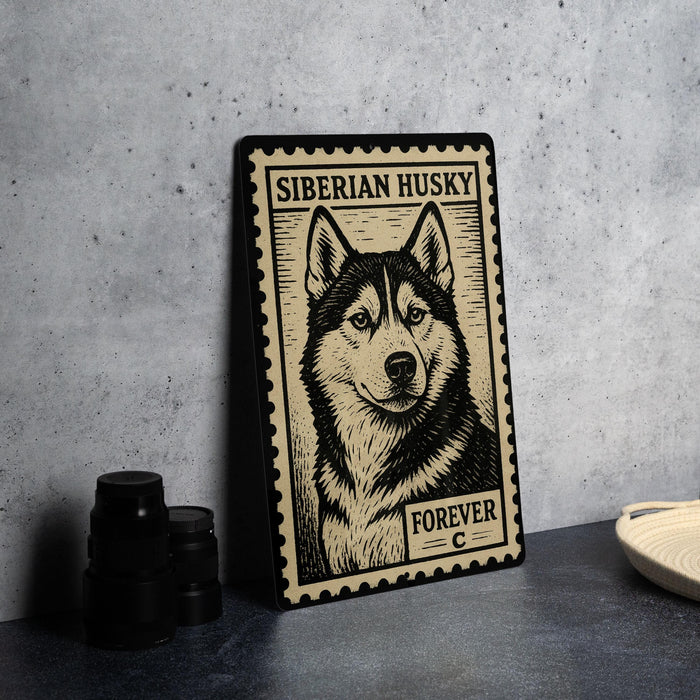 A framed poster of a Siberian husky dog is displayed on a wall, with a stack of black camera lenses and a woven basket visible to the side.