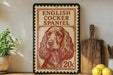 A framed illustration of an English Cocker Spaniel dog, with the text "English Cocker Spaniel" and "20c" printed on it, is displayed on a shelf next to a wooden cutting board and some lemons.