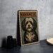 A metal sign with a stylized illustration of a dog, labeled "HAVANESE", is displayed on a table next to some black camera lenses.