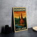 A metal sign with a vintage-style illustration of a church and a river, along with the text "ROVANIemi Finland" on it, is displayed on a table.