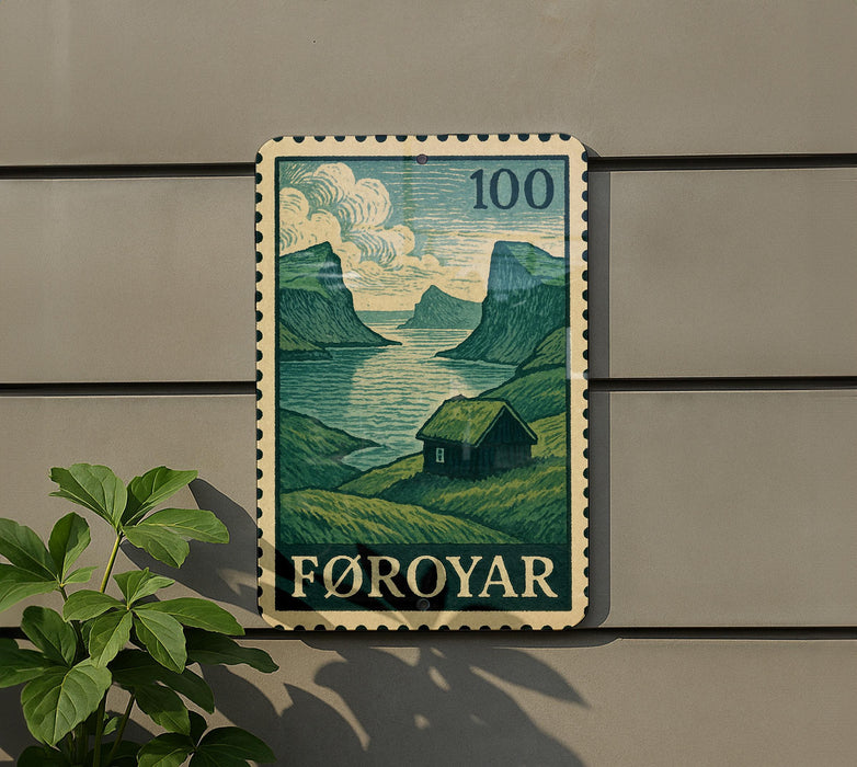 a postage stamp with a landscape scene, mounted on a wall next to a plant.