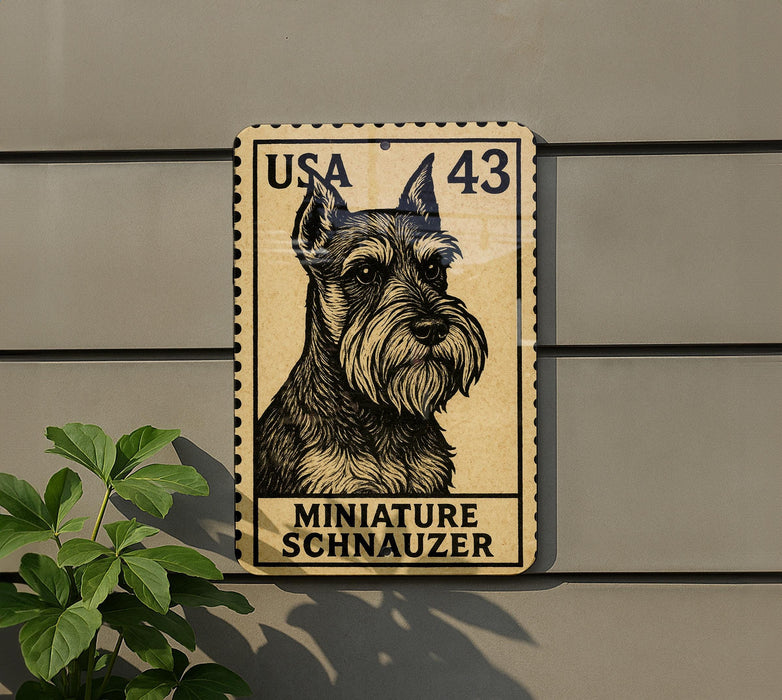 A miniature schnauzer dog stamp is displayed on a wall, with a plant to the left.