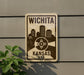 A sign displaying the name "WICHITA" and "KANSAS USA" with a graphic of a city skyline.