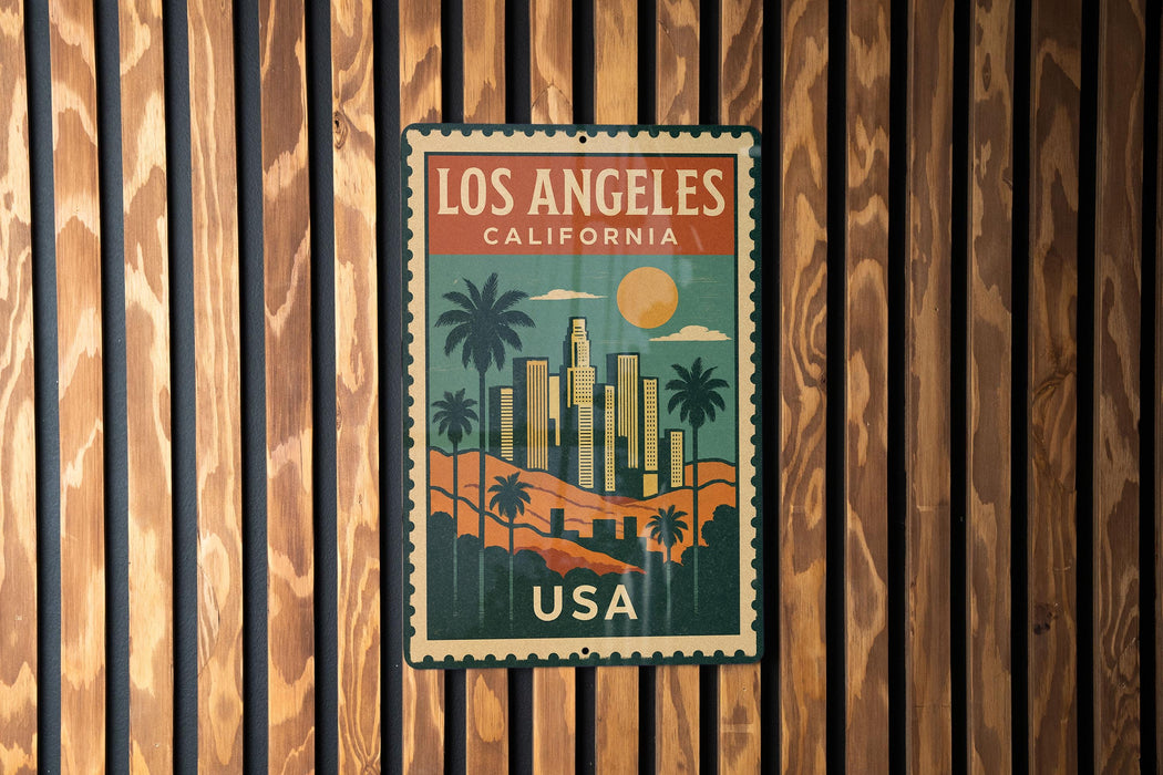A vintage-style metal sign with the text "LOS ANGELES CALIFORNIA USA" displayed on a wooden wall.
