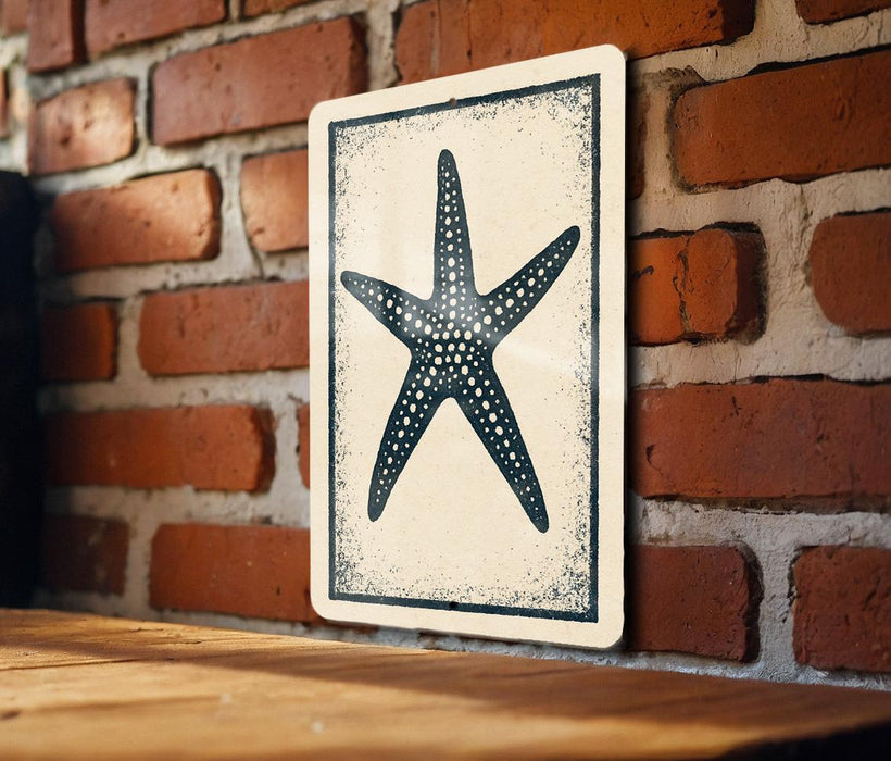 a wooden table with a framed picture of a starfish hanging on the wall behind it.
