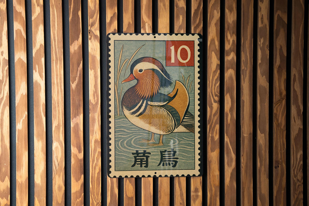 A metal stamp featuring a colorful illustration of a bird, likely a duck, with the number 10 and some text in a foreign language.