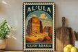 A vintage-style metal sign with the text "AL-ULA SAUDI ARABIA" and an illustration of a desert landscape with a temple or monument in the background.