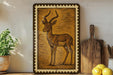 a framed illustration of a gazelle or antelope, which is the central focus of the scene. The gazelle is depicted in a detailed and realistic manner, with its distinctive curved horns and elegant posture. The gazelle is surrounded by various kitchen utensils and items, such as a wooden cutting board, a knife, a spoon, and a bowl. Additionally, there are some lemons placed nearby, adding a touch of color and freshness to the scene.