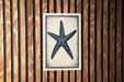 a starfish on a wooden wall.