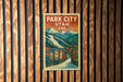 A vintage-style postage stamp depicting a town in Utah, USA, with mountains in the background.